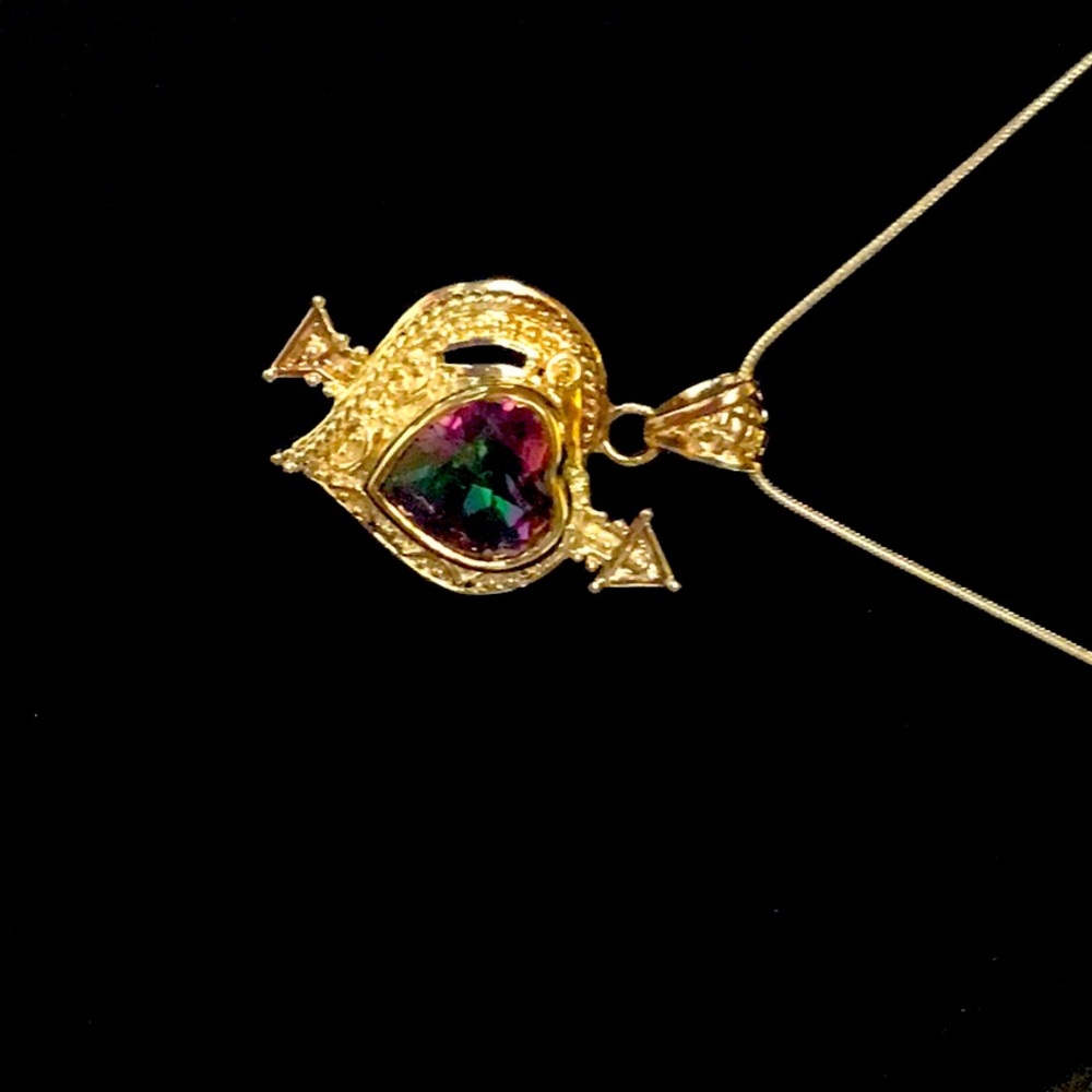 Mystic topaz heart with arrow thru it.  A commitment’s to love.